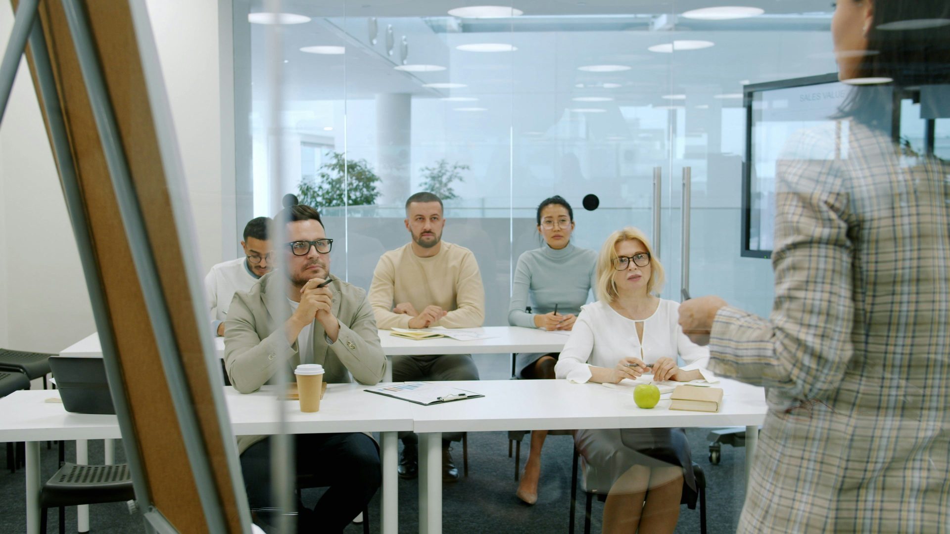 Business people attending a presentation in a modern office.